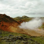 steam erupting from rocky, barren ground