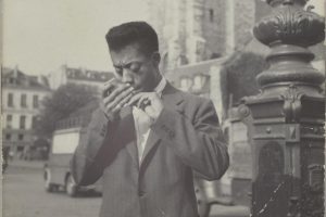 Black and white photo of James Baldwin in Paris